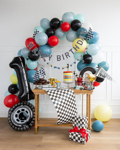 Colorful balloon arch mimicking a race car starting line